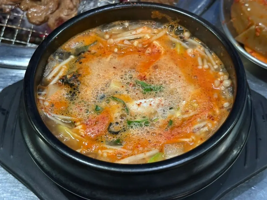 Complimentary corn snail miso soup in a stone pot