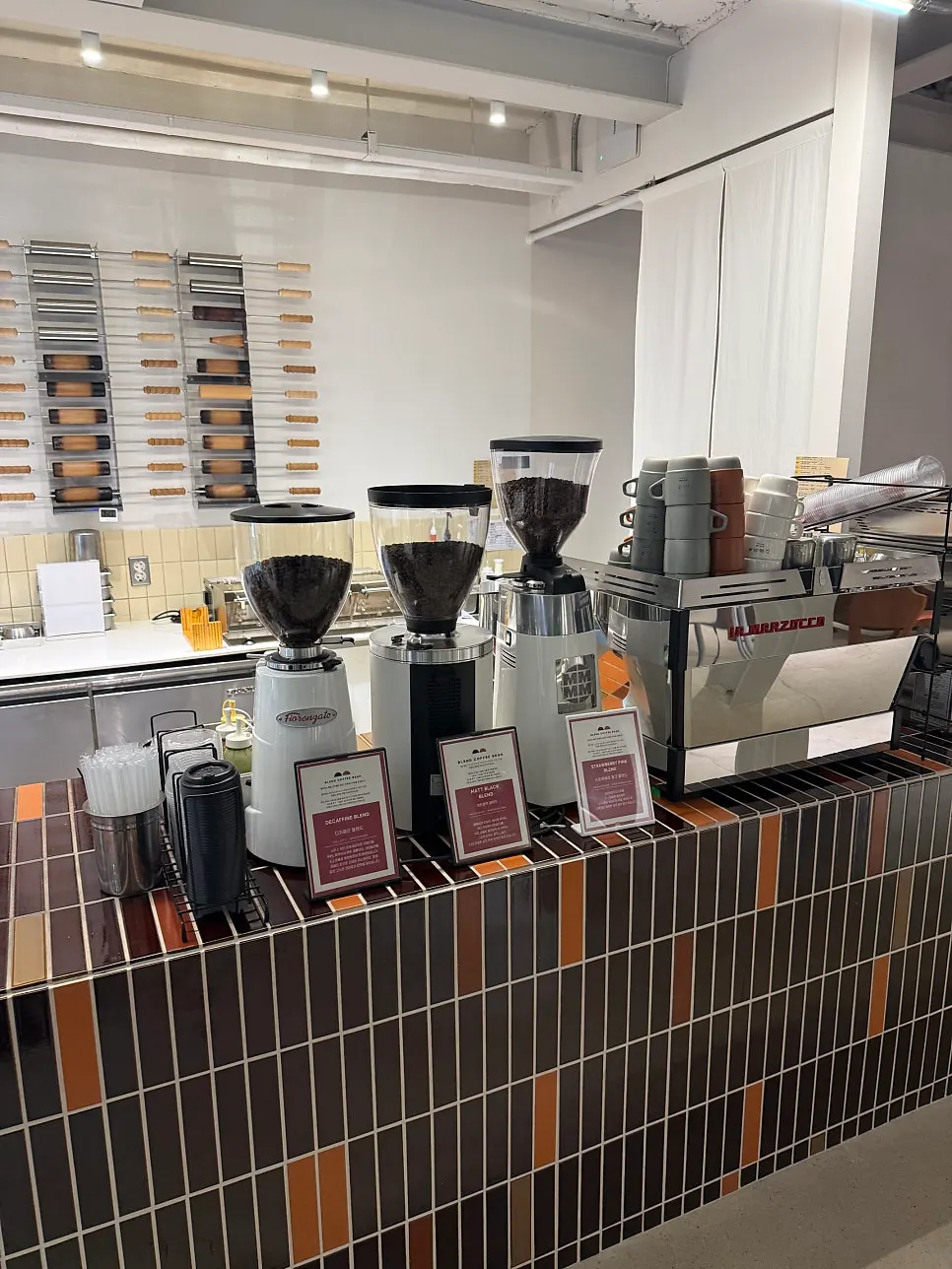 Drink bar area with organized coffee grinder and syrups