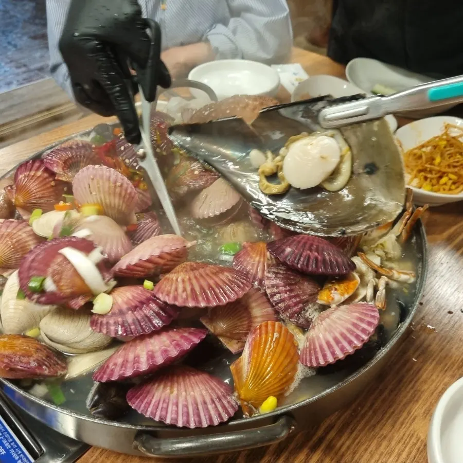 Seafood stew showing crab packed with meat