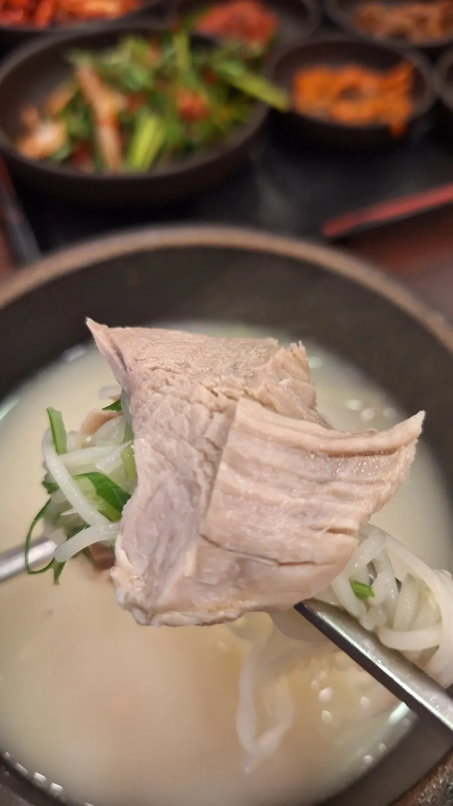 A lettuce wrap holding a piece of suyuk
