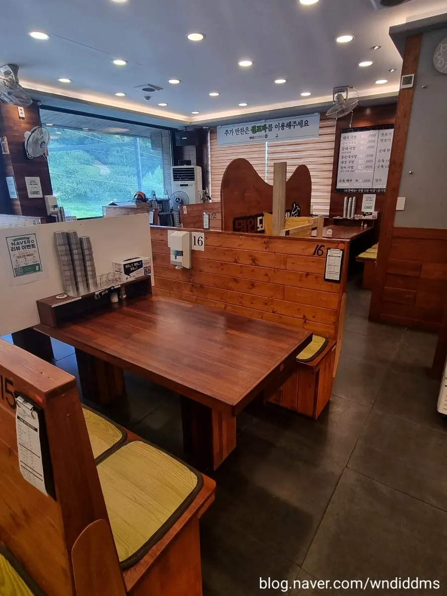 Interior of Myeongin Dwaeji Gukbap with partitioned tables