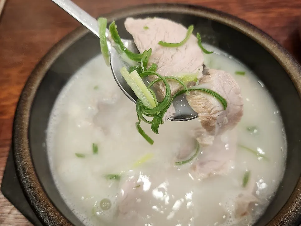 숟가락으로 떠올린 돼지국밥 국물