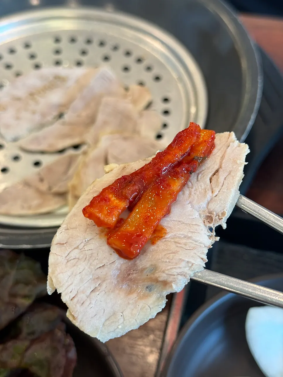 A piece of boiled pork with pickled radish