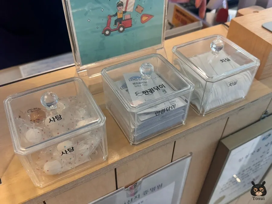 Candy and glasses cloths by the checkout counter