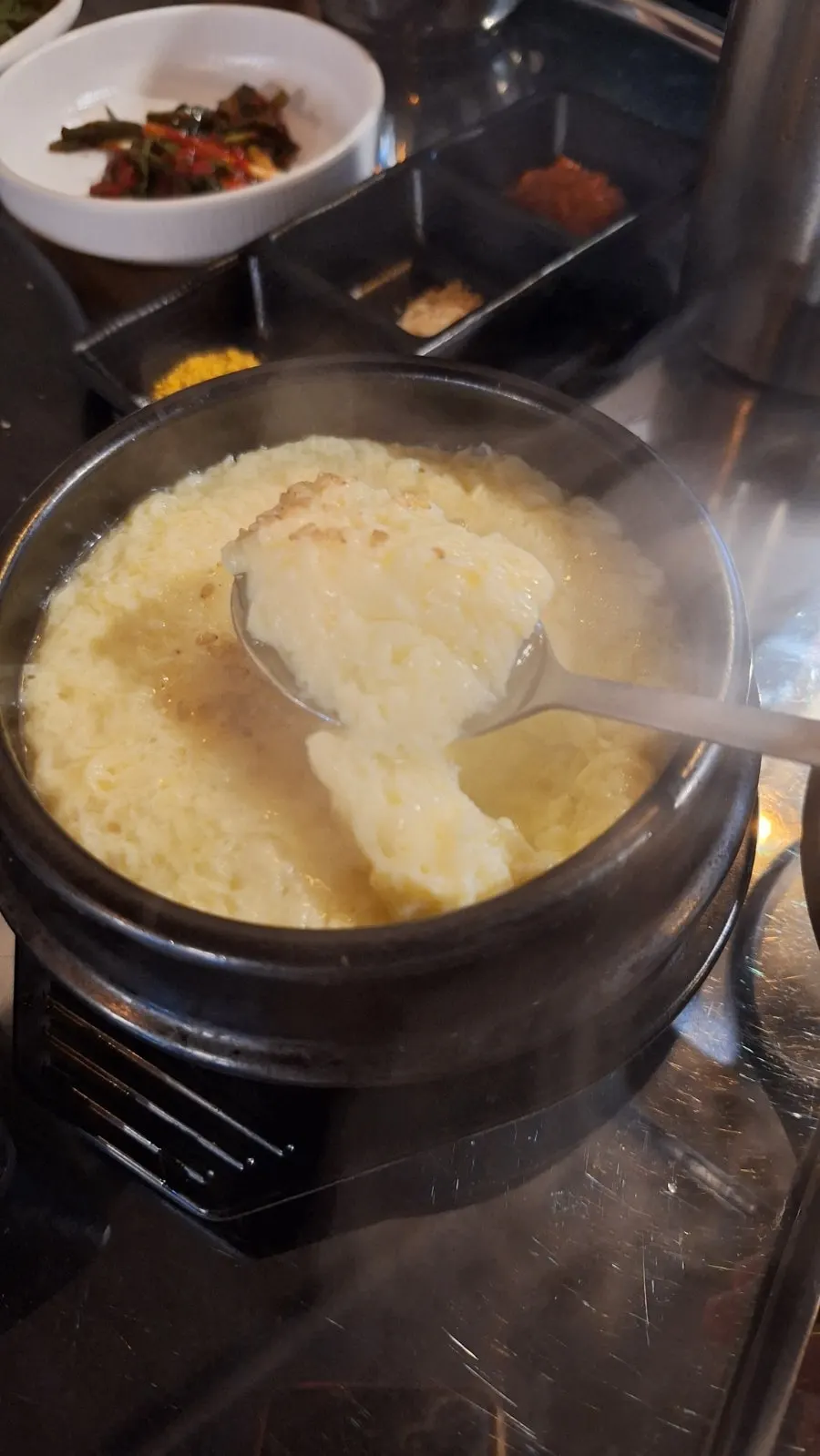 Steamed egg topped with sesame oil and sesame seeds