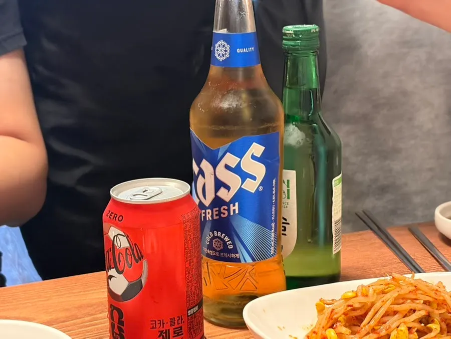 Soju, beer, and zero-sugar cola served alongside the seafood