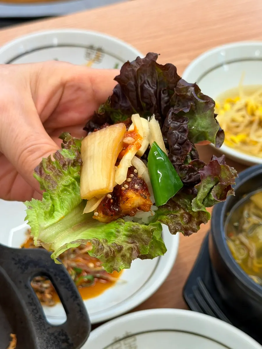 A bite combining grilled eel with pickled ginger