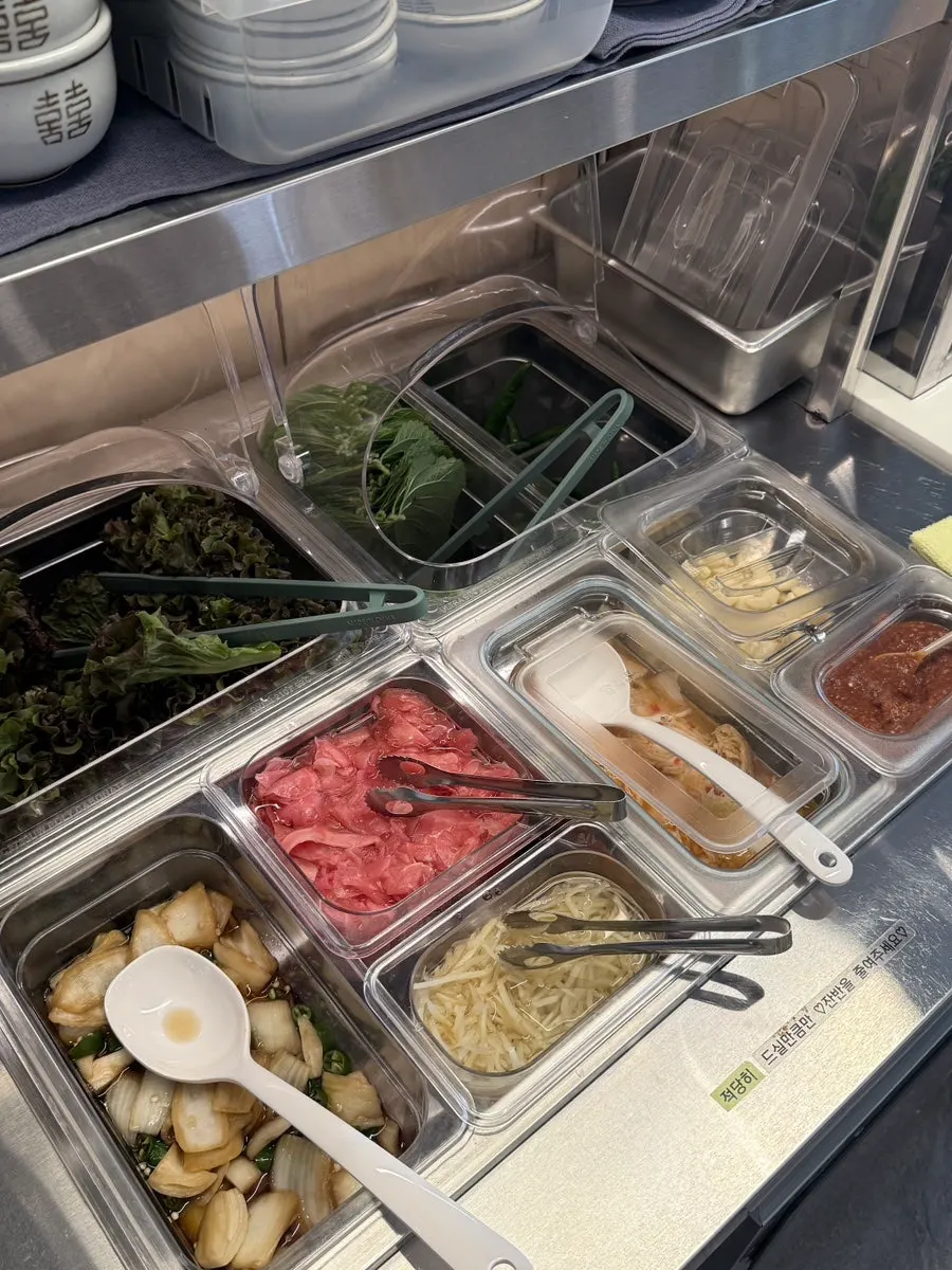 Extra side dishes neatly arranged at the self-serve bar