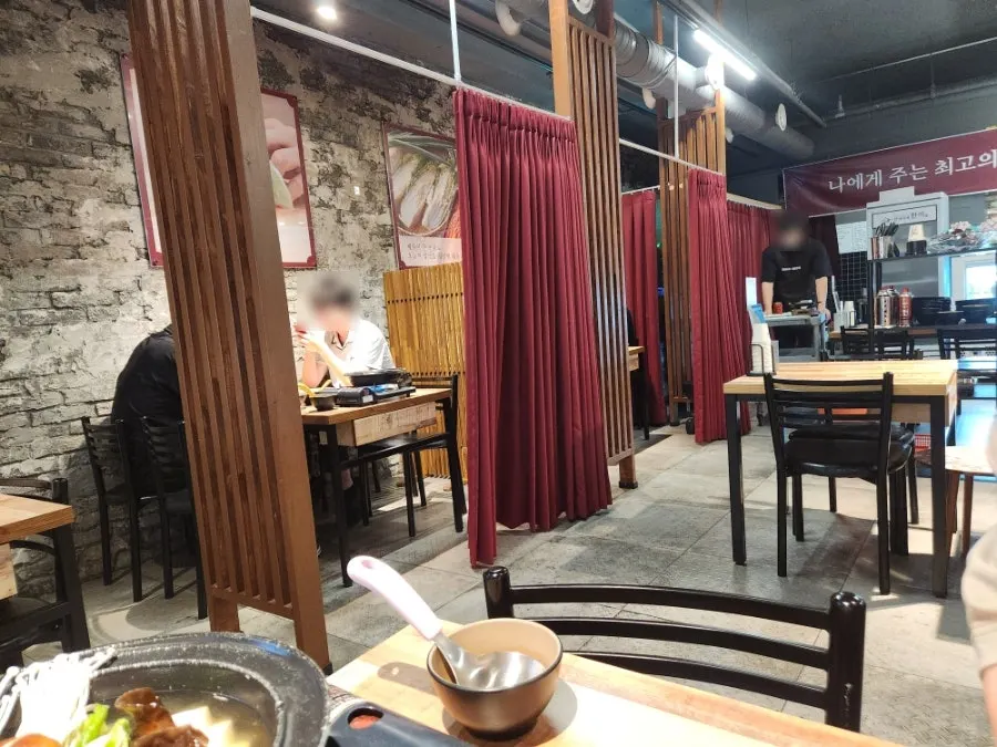 Restaurant interior with tables divided by curtains