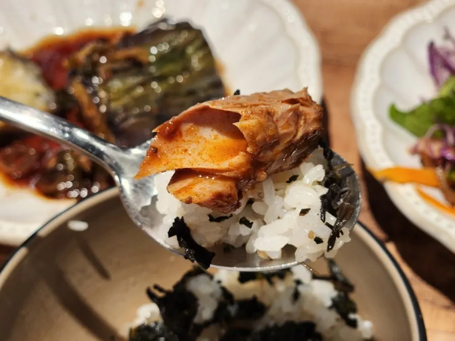 A spoonful of gondeurae rice topped with side dishes