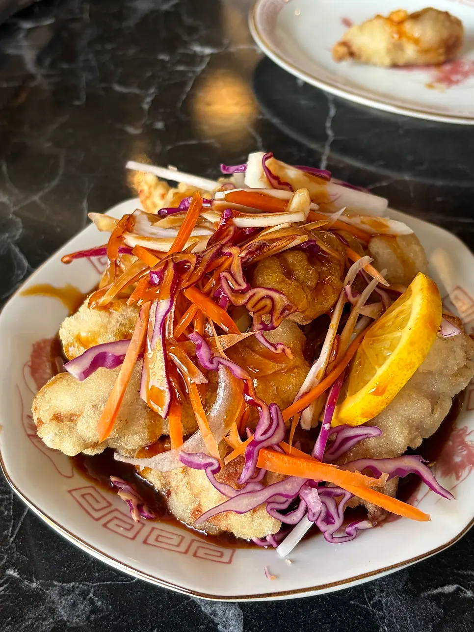 Juicy tangsuyuk topped with shredded cabbage and carrot