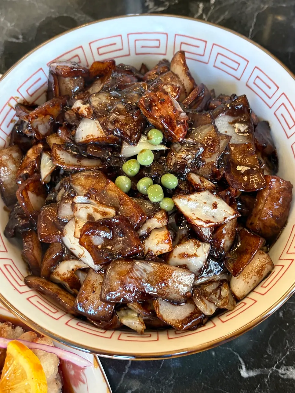 Ganjjajang noodles topped with chunky onion pieces
