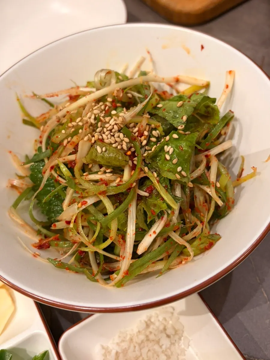 Side dishes including seasoned scallions and green-onion kimchi
