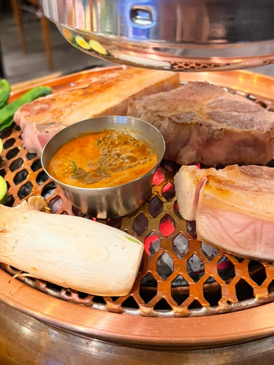 Black pork cooking over charcoal