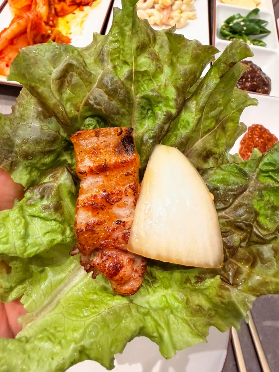 Black pork served with lettuce wraps and side dishes
