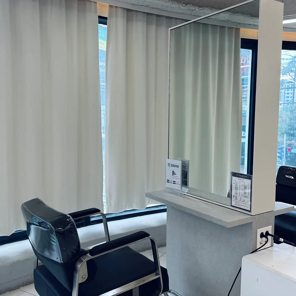Salon interior in white and gray tones with floor-to-ceiling windows