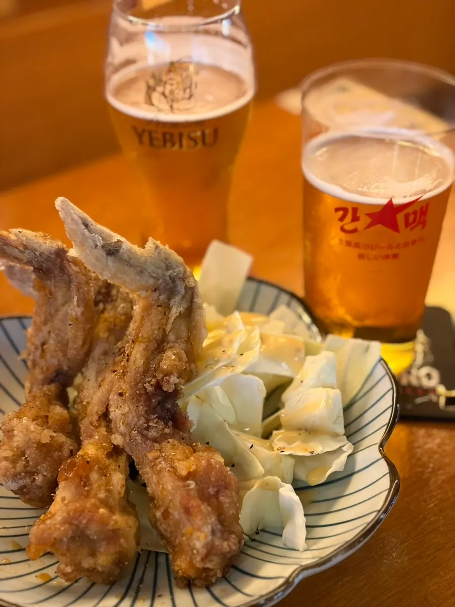 Glass of Sapporo draft beer with a frothy head
