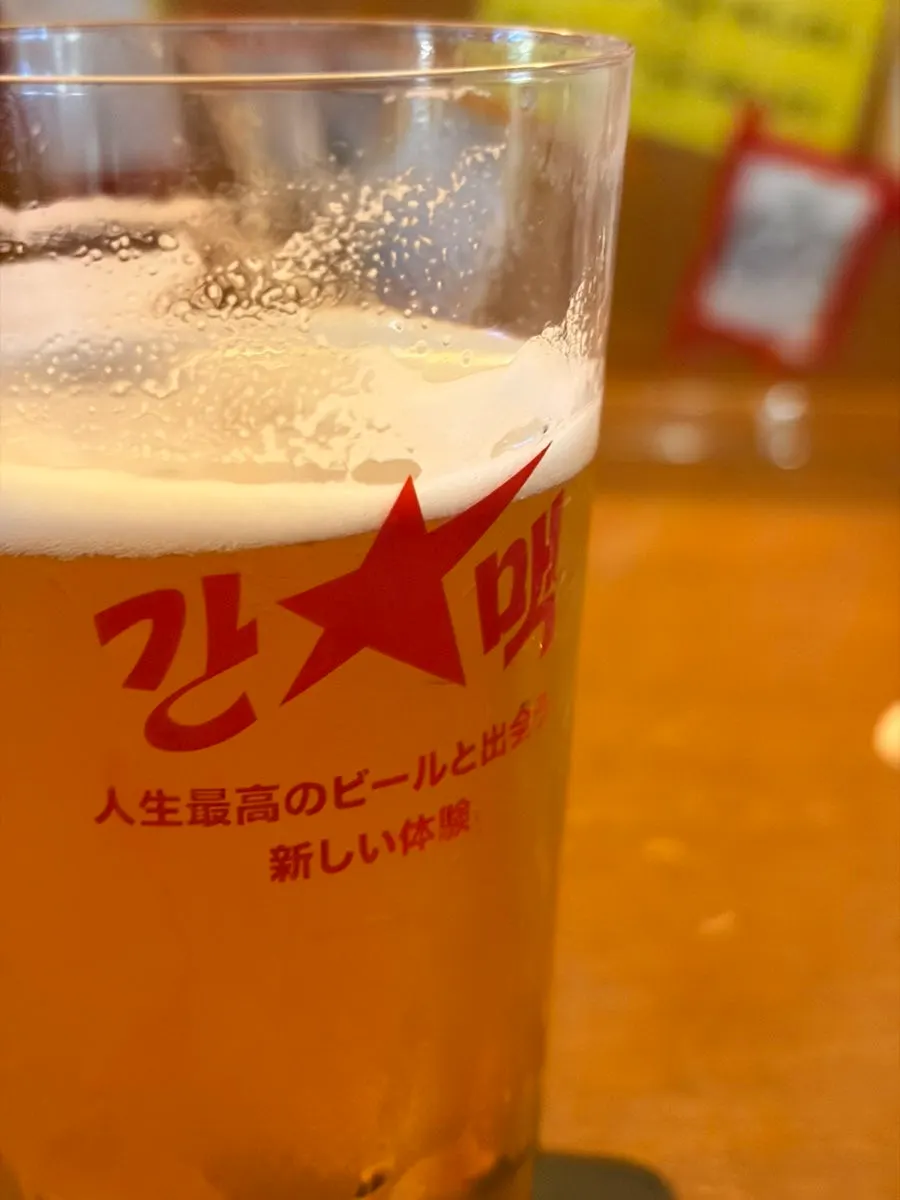 Two glasses of Sapporo and Ebisu draft beer