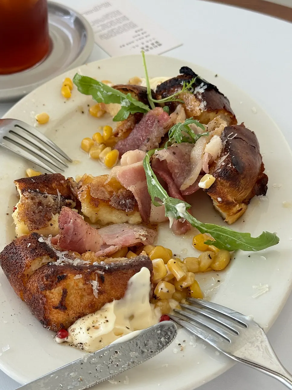 Close-up of French toast topped with corn and bacon
