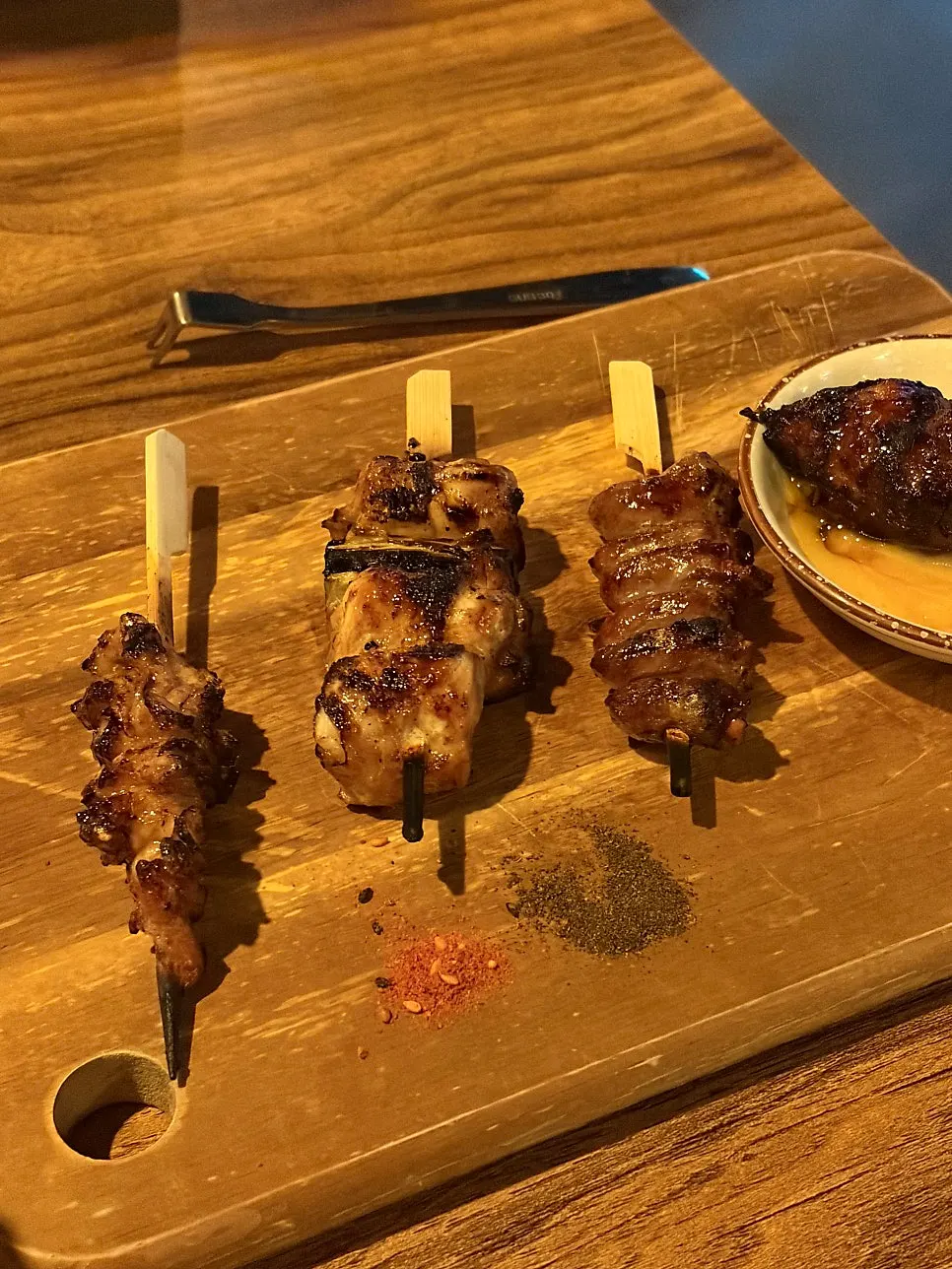 Skewers and beer set on the table together