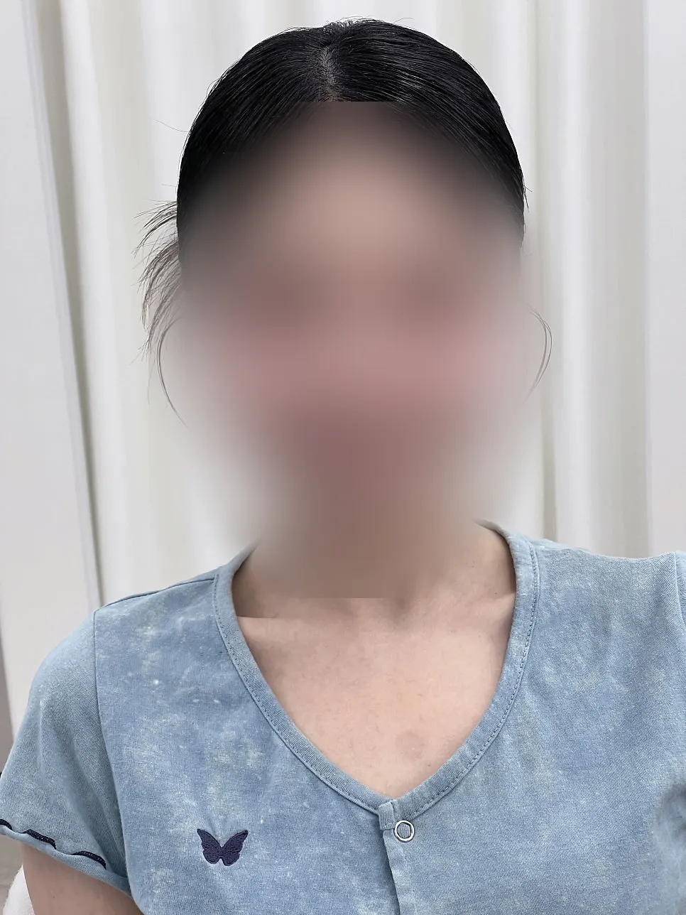 Side view of low bun hair with baby hairs left out