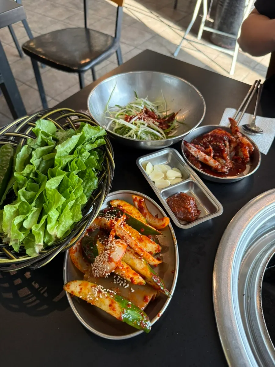 Spread of side dishes including seasoned crab and cucumber jelly salad