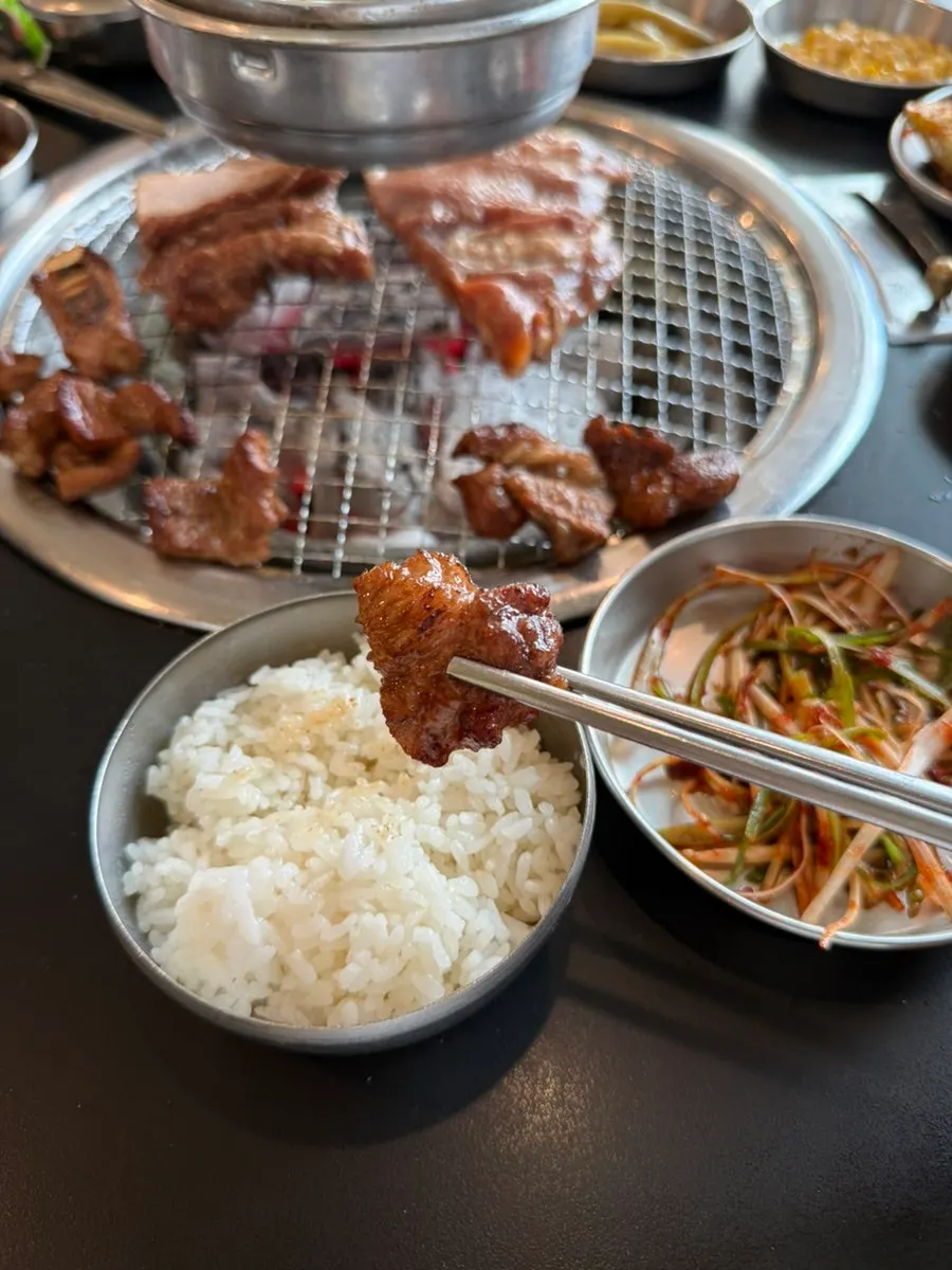 Table full of pork ribs and side dishes