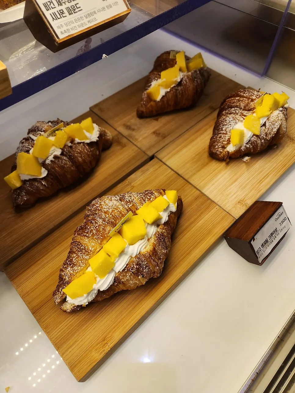 Display of fresh cream mont blanc, madeleines, and baked snacks