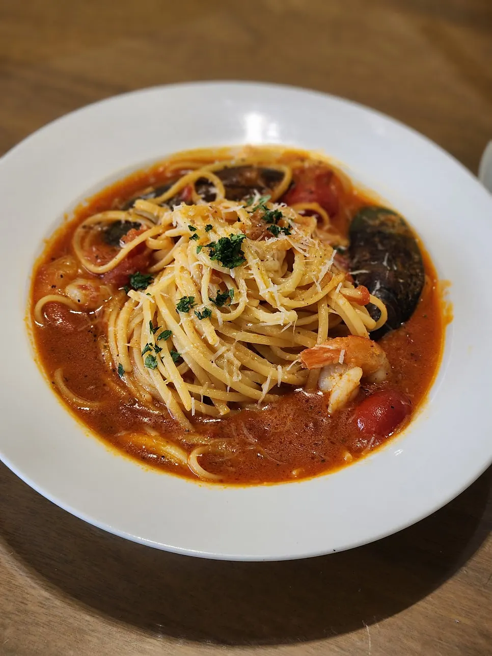 A plate of spicy tomato seafood pache pasta