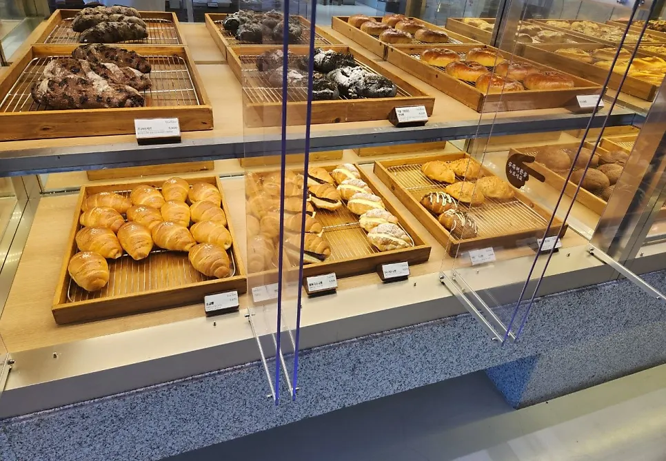 Second-floor seating at Chat Baker lit by floor-to-ceiling windows
