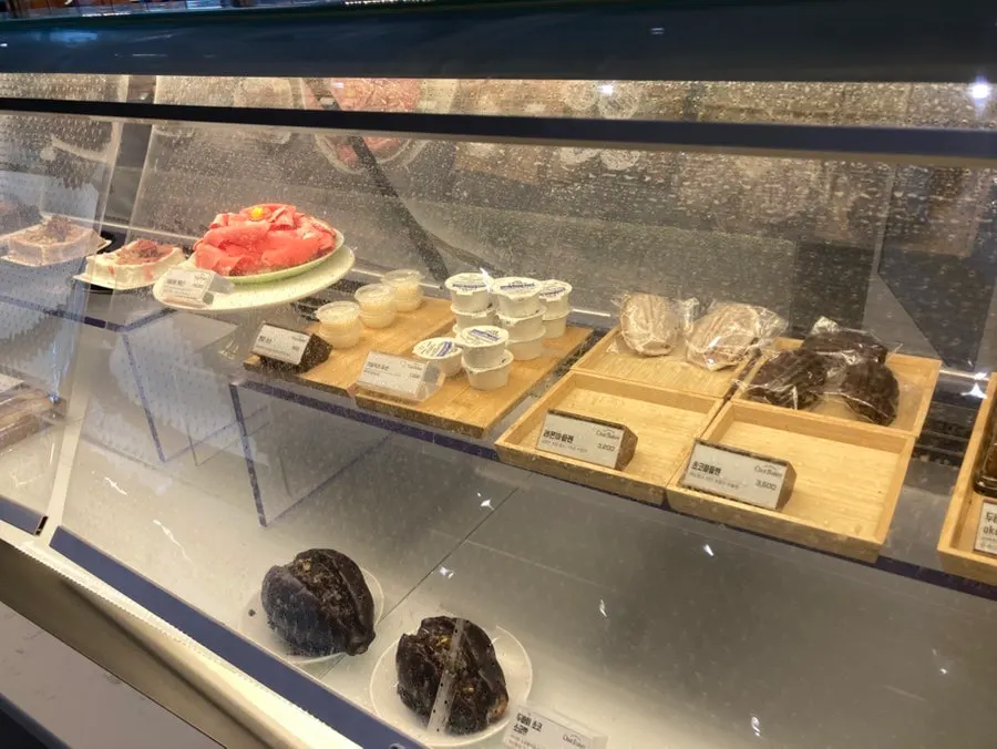 Bread display case at Chat Baker with a push-button door
