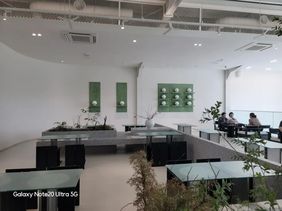 Second-floor seating and plant interior at Chat Baker