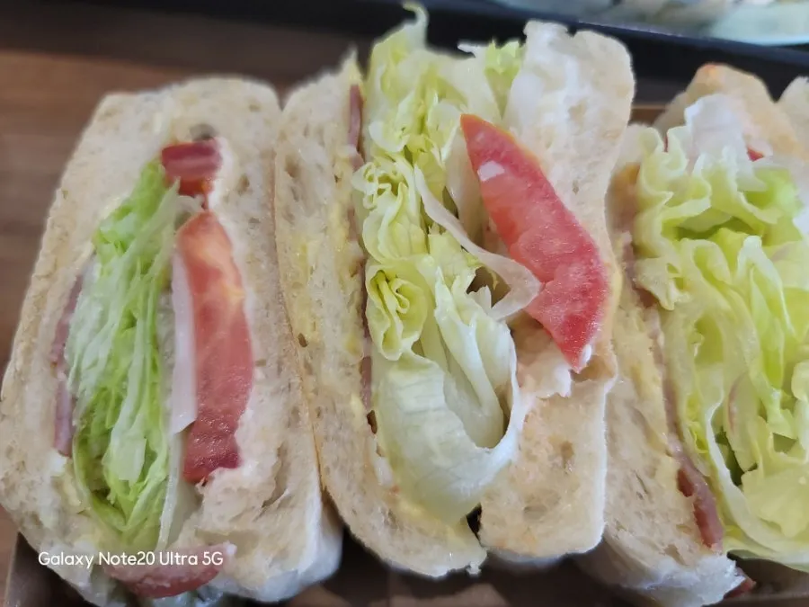 Cross-section of the pizza ciabatta sandwich with vegetables and tomato