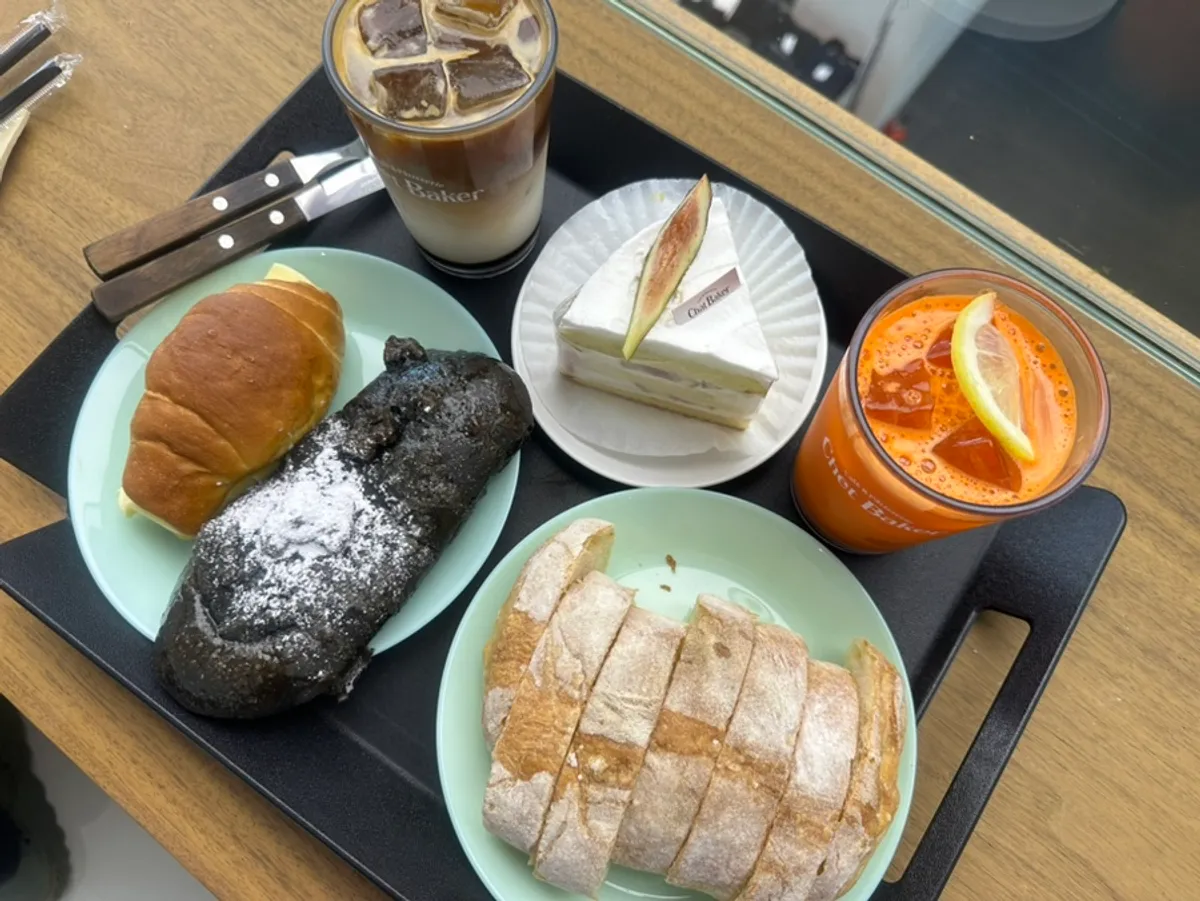 Four kinds of bread and two drinks laid out on the table