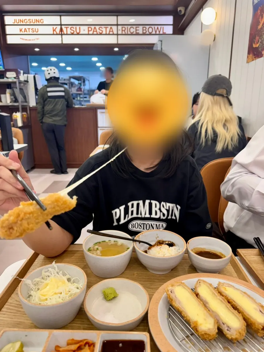 Cheese stretching from the cheese-loaded katsu on chopsticks