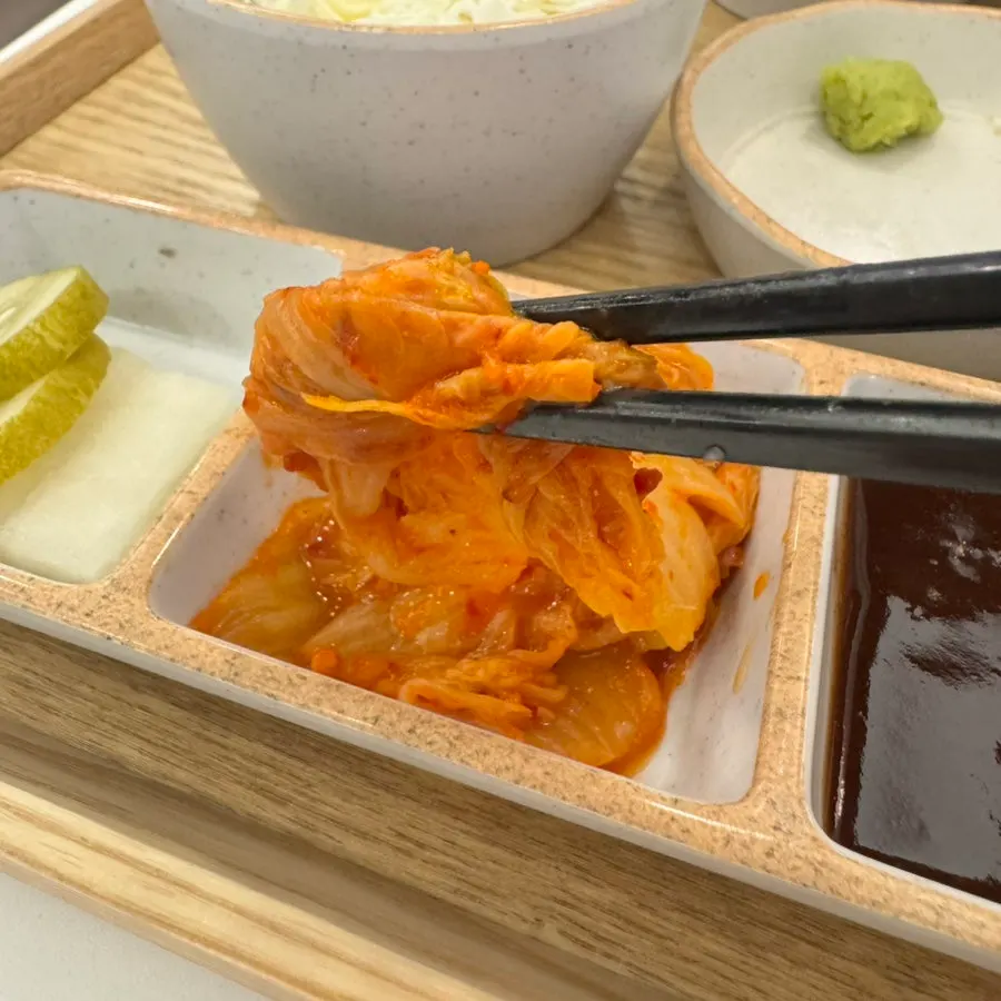 A piece of katsu dipped in wasabi and salt