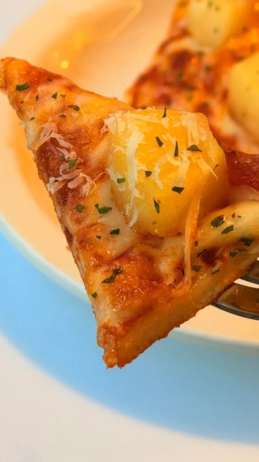 Cross-section of the pizza showing chunky pineapple pieces