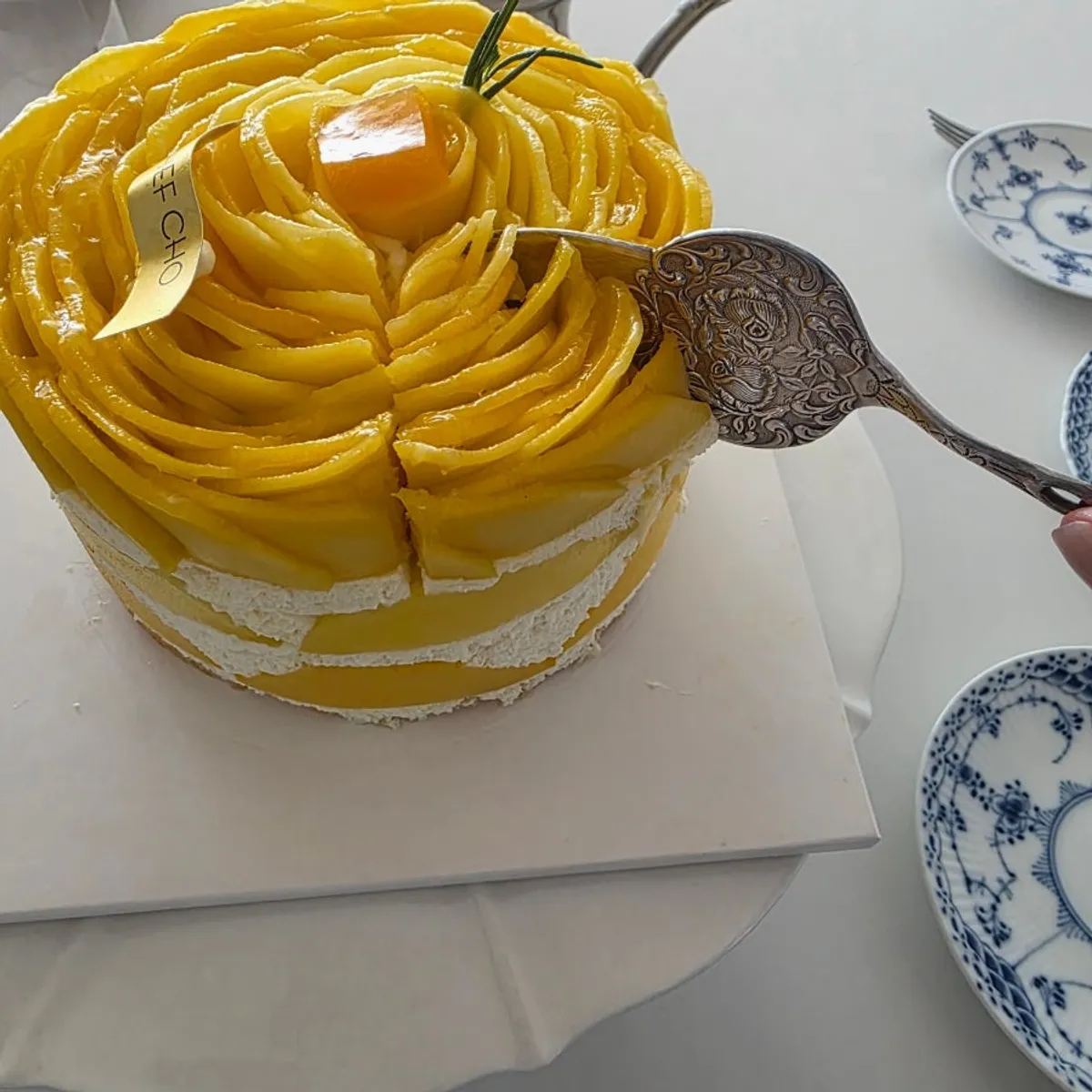 Real mango rose cake with the mango cut first using scissors