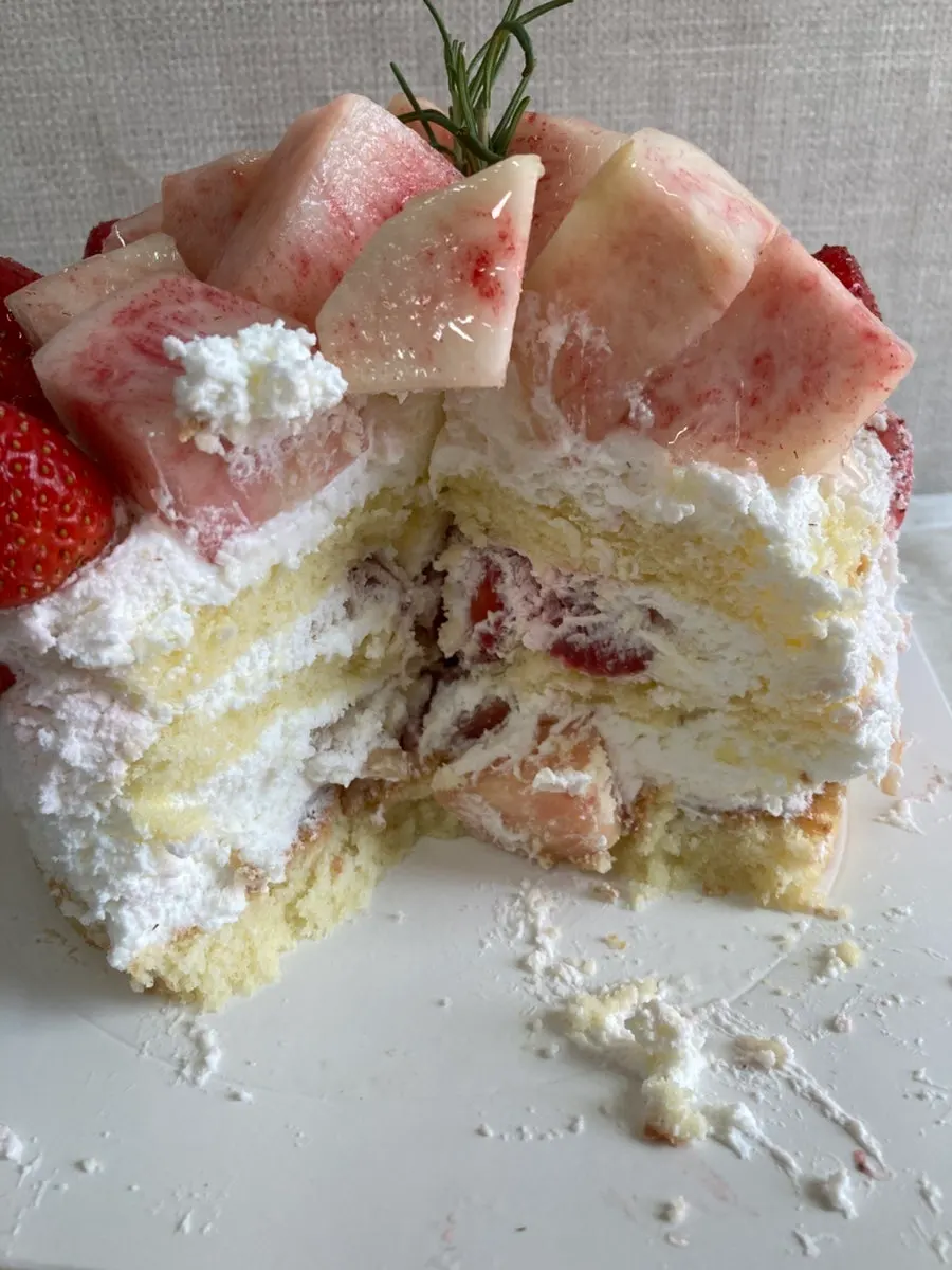 Fruit spilling out as the cake is cut