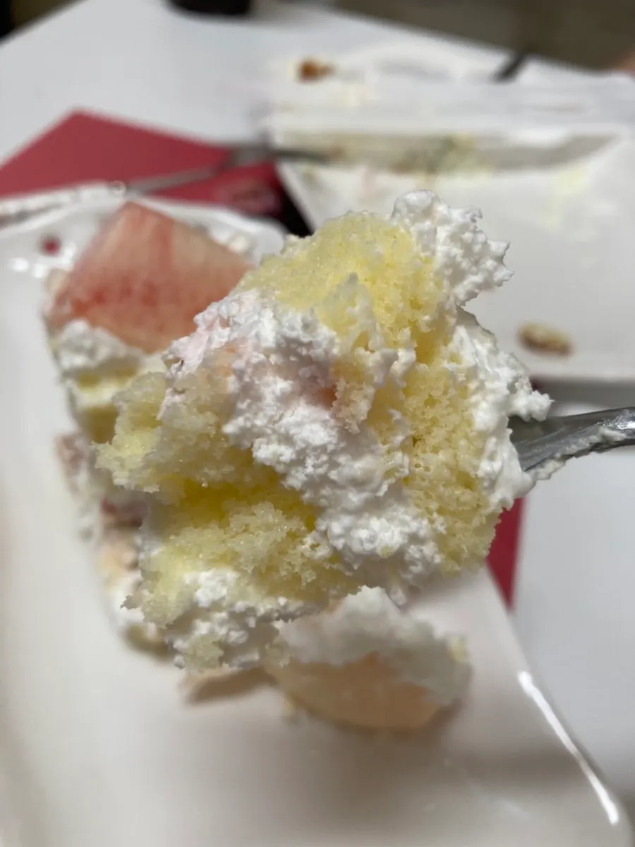 Cross-section of the cake showing strawberries and peaches layered inside