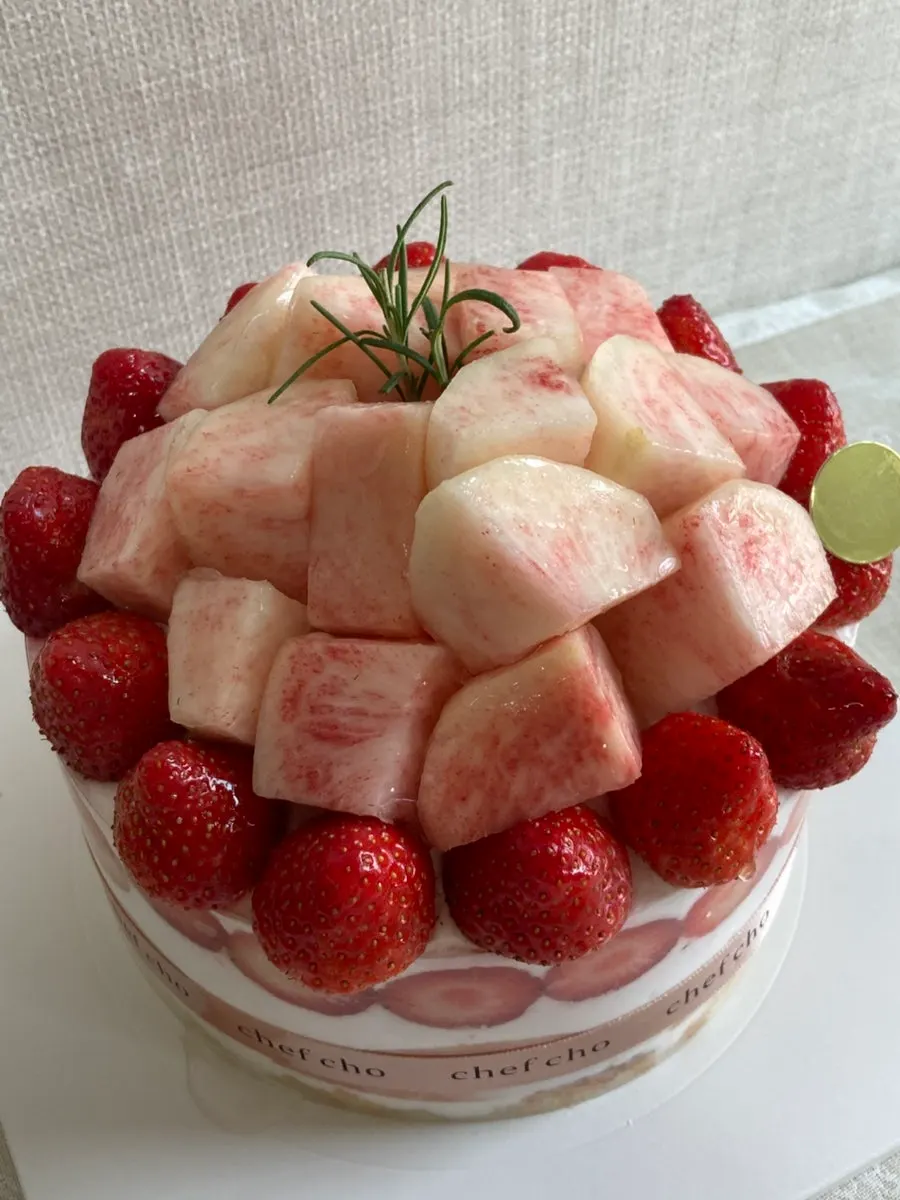 A cake slice showing peaches and whipped cream together