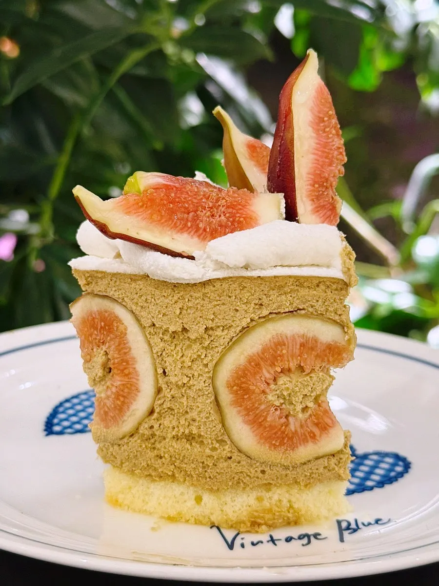 A slice of fig pistachio cake served on a plate