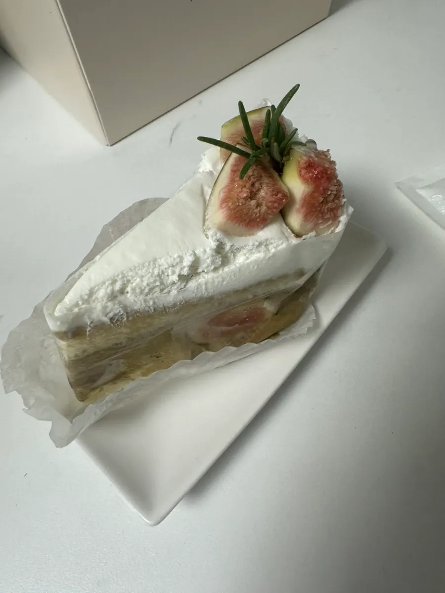 A bite taken out of the fig pistachio slice cake