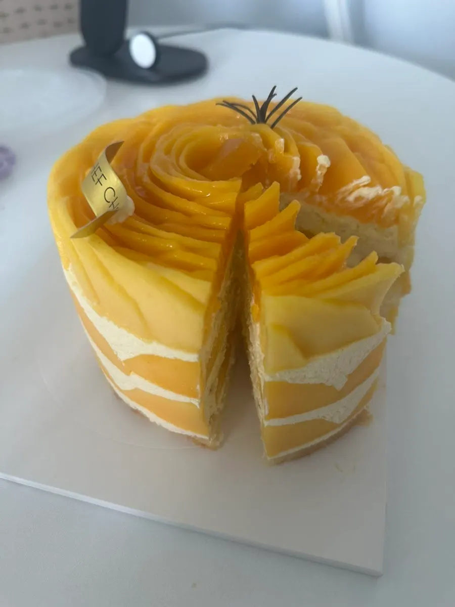 Cross-section of the mango cake cut open, full of mango