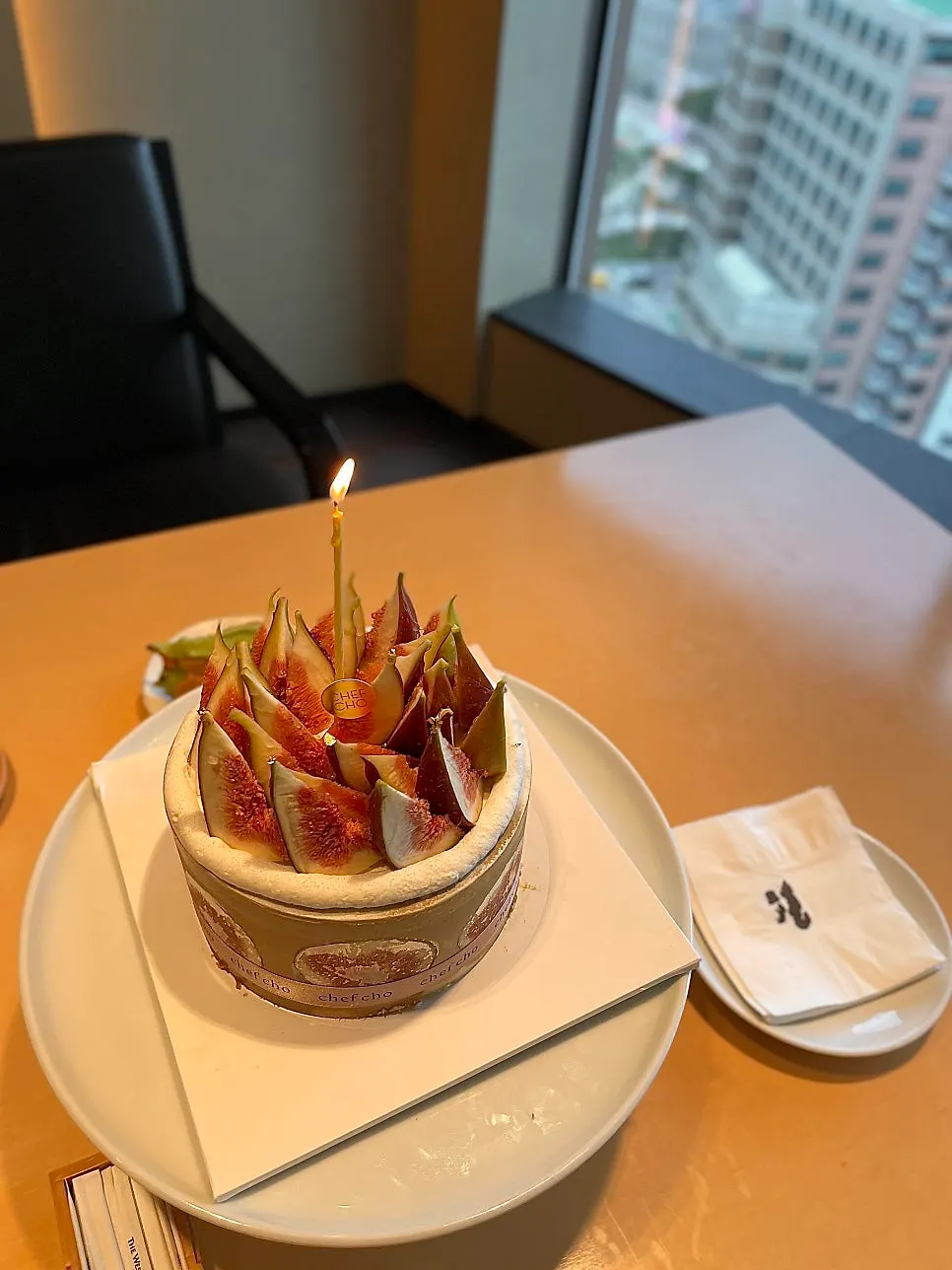 Birthday cake set up with lit candles