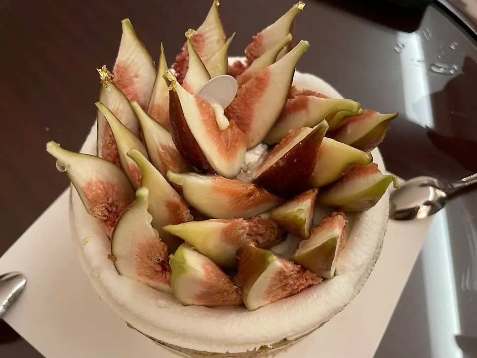Side of the cake showing pistachio cream and fig cross-sections