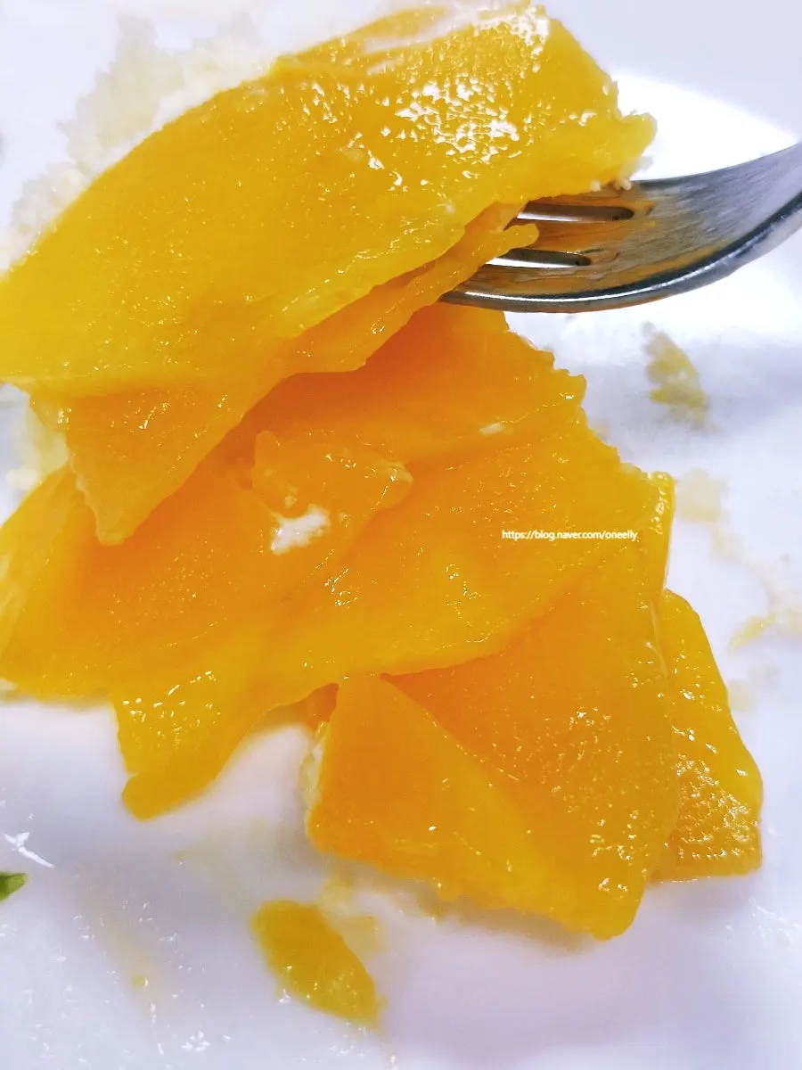 A slice of the Mango Rose cake on a plate