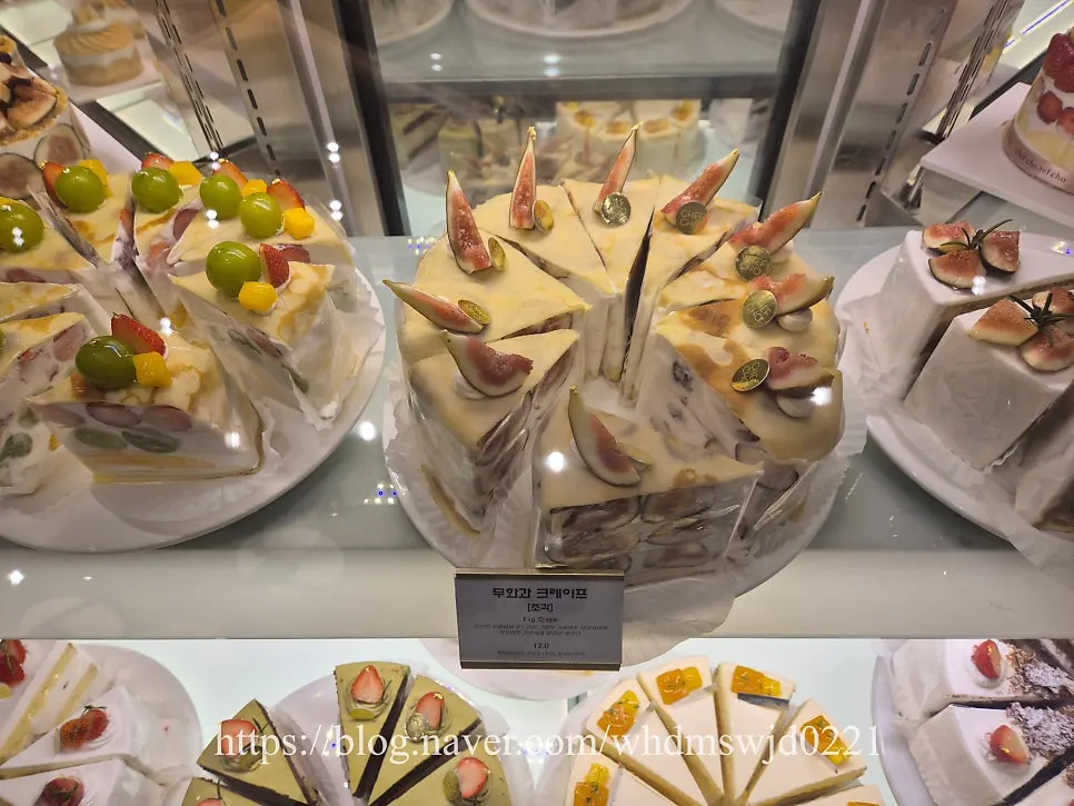 Slice cakes including matcha chocolate cake on display at Chef Cho