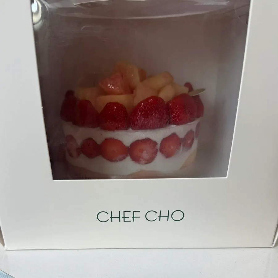 Peach Berry cake visible through the box window