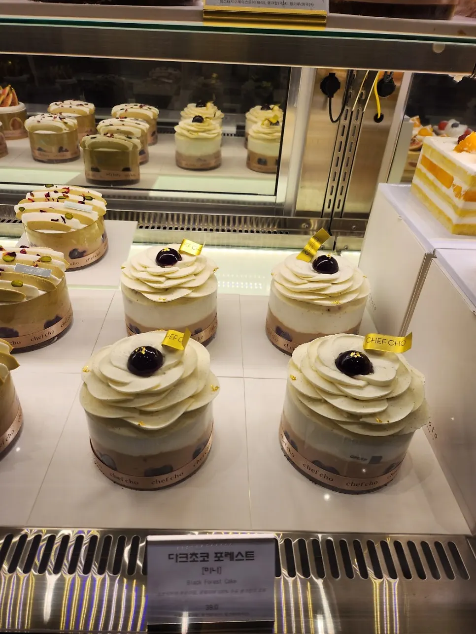 Fruit-topped cakes on display at Chef Cho